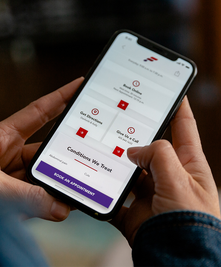 Person holding phone using First Med Mobile App